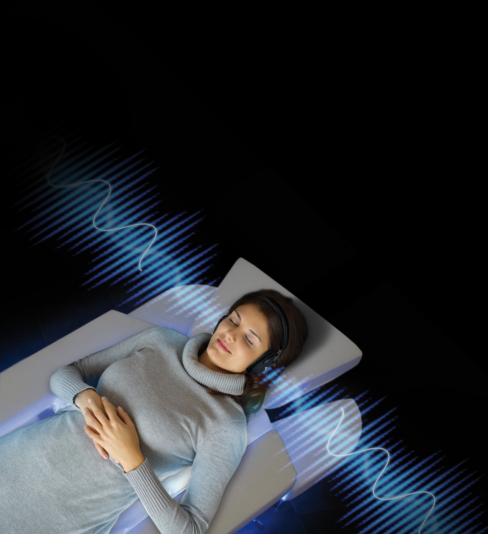 Woman relaxing with her eyes closed on bed wearing headphones