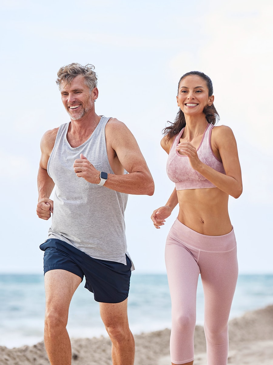 Man and woman jogging on the beach